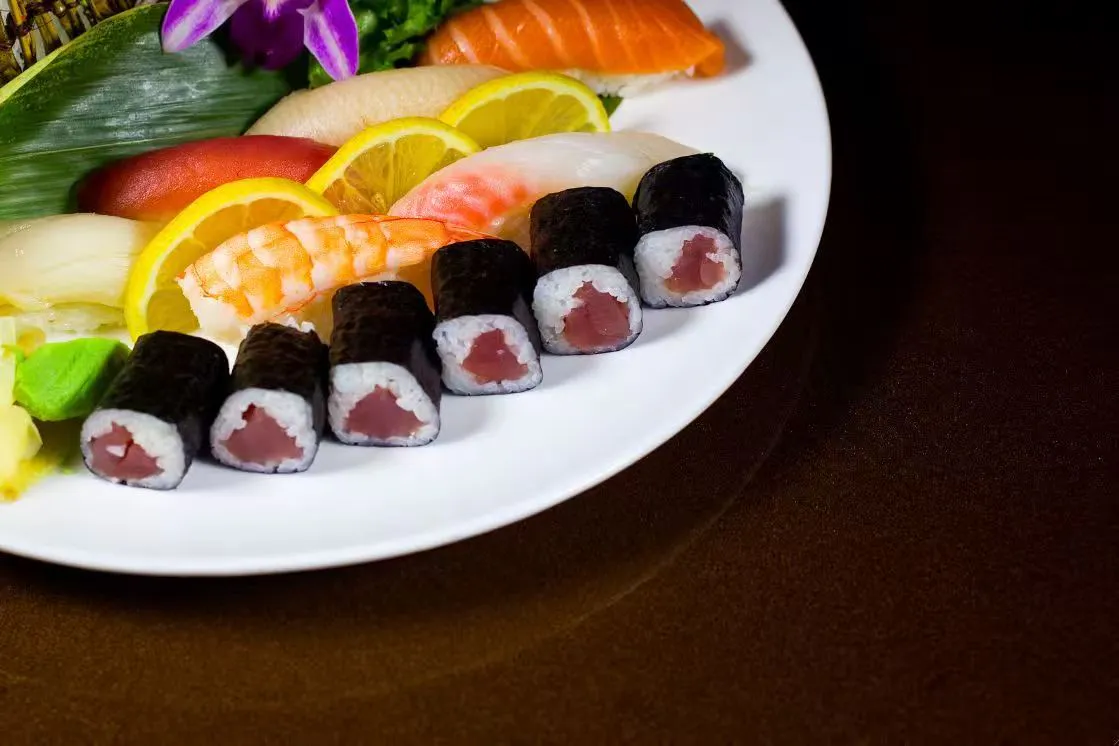 Assorted sashimi and tuna maki platter with lemon and wasabi side at Midori Sushi Of Highland Park, a Japanese Restaurant in Highland Park